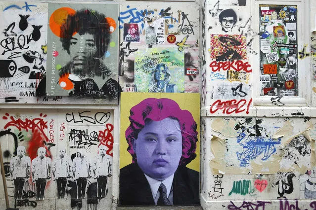 Political street art depicting musician Jimi Hendrix (top L) and North Korean leader Kim Jong-un (bottom C) are seen near Brick Lane in east London January 14, 2015. (Photo by Luke MacGregor/Reuters)