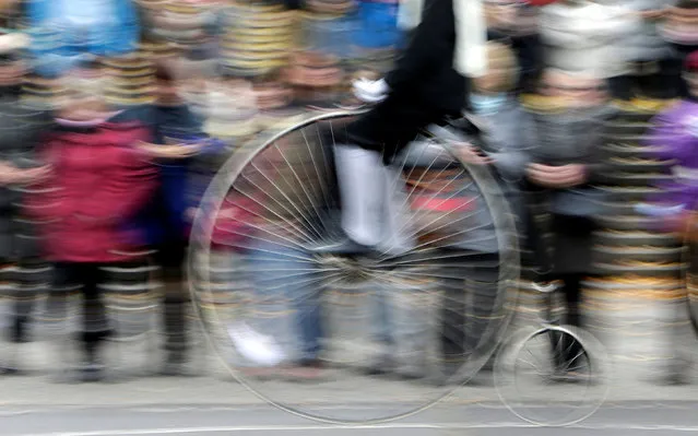 A man wearing a historical costume rides his high-wheel bicycle during the annual penny farthing race in Prague, Czech Republic November 5, 2016. (Photo by David W. Cerny/Reuters)