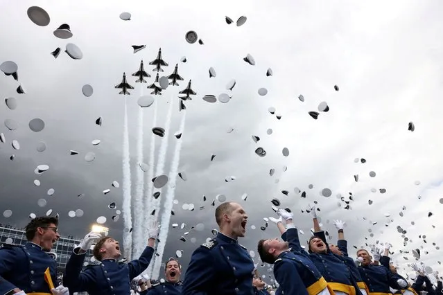 U.S. Air Force jets fly overhead as USAF Academy cadets celebrate during their graduation ceremony attended by President Joe Biden at Falcon Stadium in Colorado Springs, Colorado, U.S., June 1, 2023. (Photo by Kevin Mohatt/Reuters)
