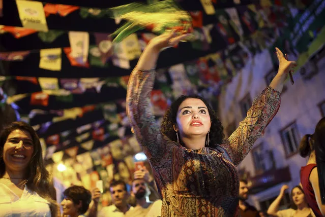 Women dance under election banners of the pro-Kurdish Peoples' Democratic Party, or HDP, in the mainly-Kurdish city of Diyarbakir, southeastern Turkey, Sunday, June 24, 2018. Partial results show the pro-Kurdish party has passed a critical electoral threshold to enter the Turkish parliament, risking the ruling party's majority. (Photo by Emre Tazegul/AP Photo)