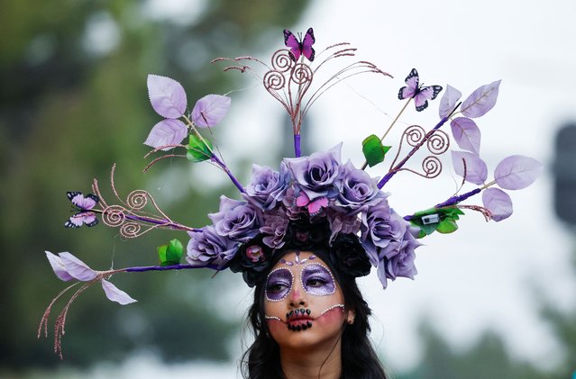 A woman dressed as a Catrina takes part in the annual parade of Catrinas on the Day of the Dead, in Saltillo, Mexico on November 2, 2024. (Photo by Daniel Becerril/Reuters)