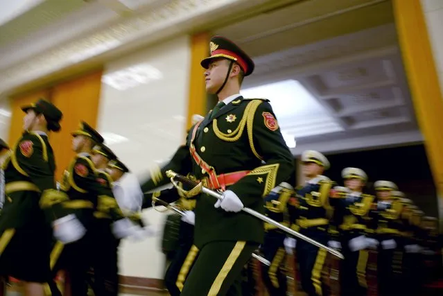 Chinese honour guards prepare for the arrival of Iraqi Prime Minister Haider al-Abadi and Chinese Premier Li Keqiang during a welcome ceremony at the Great Hall of the People in Beijing on December 22, 2015. (Photo by Wang Zhao/Reuters)