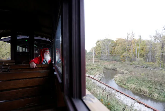 Santa Sam Hopeck of Commerce Township, Michigan rides the Polar Express train during a field trip from the Charles W. Howard Santa Claus School in Midland, Michigan, U.S. October 28, 2016. (Photo by Christinne Muschi/Reuters)