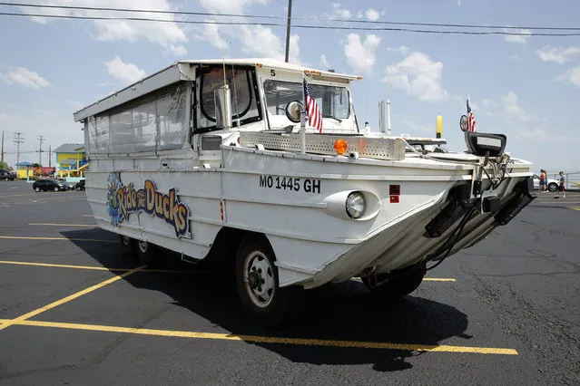 A duck boat sits idle in the parking lot of Ride the Ducks, an amphibious tour operator in Branson, Mo. Friday, July 20, 2018. The amphibious vehicle is similar to one of the company's boats that capsized the day before on Table Rock Lake resulting in 17 deaths. (Photo by Charlie Riedel/AP Photo)