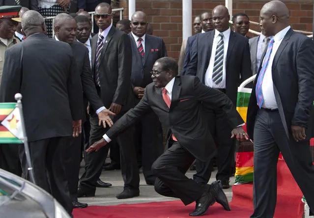 Zimbabwean President Robert Mugabe, center, falls after addressing supporters upon his return from an African Union meeting in Ethiopia, Wednesday, February 4, 2015. Mugabe, 90, was elected chairman of the African Union and is set to celebrate his 91st birthday on Feb. 21. (Photo by AP Photo)