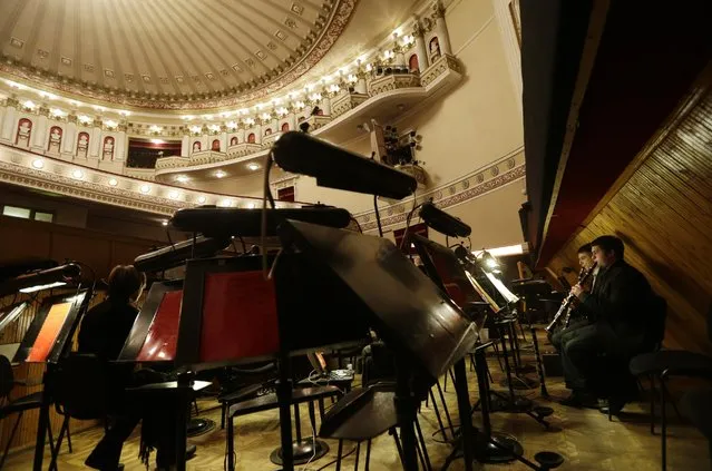 Musicians with the Donbass Opera Theatre prepare to perform Eugene Onegin in Donetsk, Ukraine, Saturday, February 7, 2015. (Photo by Petr David Josek/AP Photo)