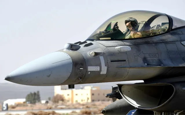 This photo released by WAM, the state news agency of the United Arab Emirates, shows an Emirati pilot in his F-16 at an air base in Jordan, Tuesday, February 10, 2015. The United Arab Emirates launched airstrikes Tuesday targeting the Islamic State group, its official news agency said, marking its return to combat operations against the militants after it halted flights late last year. (Photo by AP Photo/WAM)