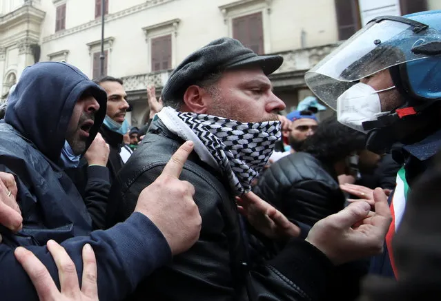 Restaurant and small business owners scuffle with police during a protest calling for their businesses to be allowed to re-open, despite no authorization for the demonstration by the government, amid the coronavirus disease (COVID-19) outbreak, in Rome, Italy, April 12, 2021. (Photo by Yara Nardi/Reuters)