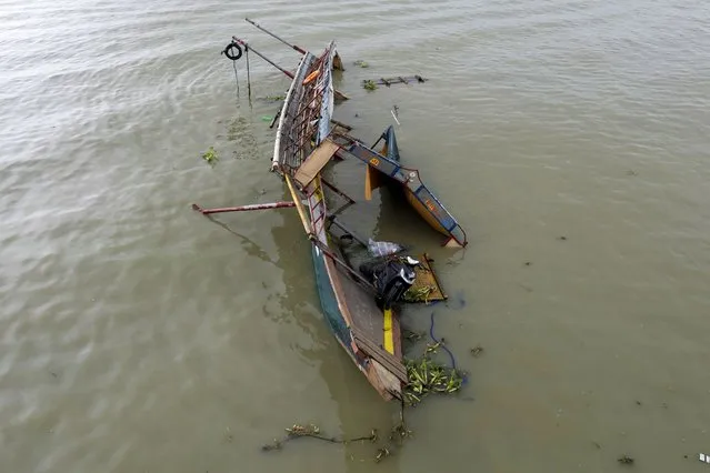 This photo taken by drone shows the remains of a passenger boat that capsized in Binangonan, Rizal province, Philippines on, Friday, July 28, 2023. The small Philippine ferry turned upside down when passengers suddenly crowded to one side in panic as fierce winds pummeled the wooden vessel, leaving several people dead while others were rescued, officials said Friday. (Photo by Aaron Favila/AP Photo)