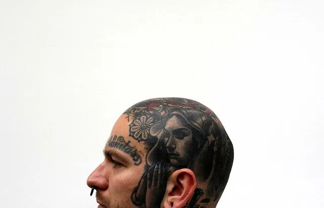 Jakub displays a tattoo on his head. (Photo by Stefan Wermuth/Reuters)