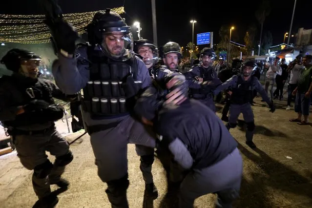 Israeli police scuffle with a Palestinian during clashes with Israeli police at Damascus Gate on Laylat al-Qadr during the holy month of Ramadan, in Jerusalem's Old City, May 8, 2021. (Photo by Ronen Zvulun/Reuters)