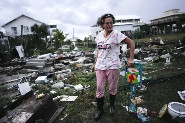 Jewell Baggett stands beside a Christmas decoration she recovered from the wreckage of her mother’s home, as she searches for anything salvageable from the trailer home her grandfather had acquired in 1973 and built multiple additions on to over the decades, in Horseshoe Beach, Fla., after the passage of Hurricane Idalia, Wednesday, August 30, 2023. (Photo by Rebecca Blackwell/AP Photo)
