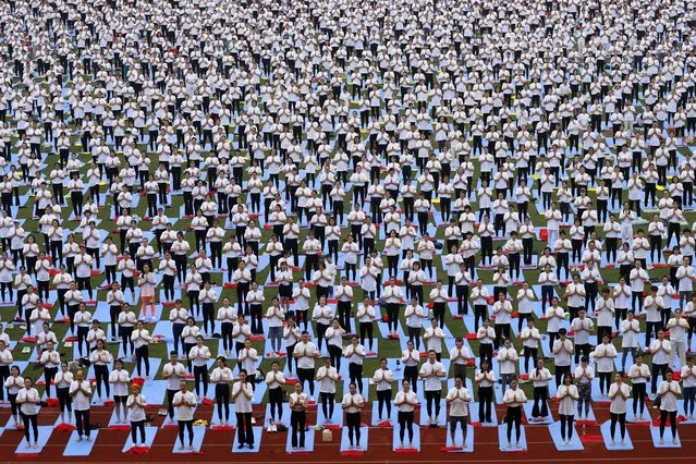 People take part in a yoga exercise at My Dinh National Stadium in Hanoi, Vietnam, 12 August 2023. Some 5,000 yoga participants joined in a yoga event at the stadium on 12 August, which is expected to set a Vietnamese Guinness record. (Photo by Luong Thai Linh/EPA)