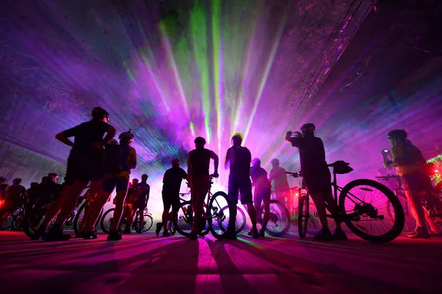 Mountainbikers take part in an event tour through the “Erlebnis Bergwerk Merkers” disused salt mine in Merkers, central Germany, on December 11, 2016. The former “Kaiseroda” potassium mine was closed down already in 1965. Since 1991, it serves as an adventure mine and offers sports and cultural events to visitors in about 800 meters under the ground. (Photo by Martin Schutt/AFP Photo/DPA)