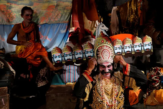 An artist dressed as demon king Ravana gets ready backstage before performing Ramlila, a re-enactment of the life of Hindu Lord Rama, during Vijaya Dashmi or Dussehra festival celebrations in Mumbai, India, October 16, 2018. (Photo by Danish Siddiqui/Reuters)