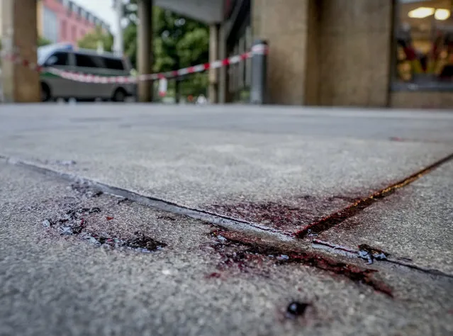 Blood is seen at the crime scene in central Wuerzburg, Germany, Saturday, June 26, 2021. German police say several people have been killed and others injured in a knife attack in the southern city of Wuerzburg on Friday.(Photo by Michael Probst/AP Photo)