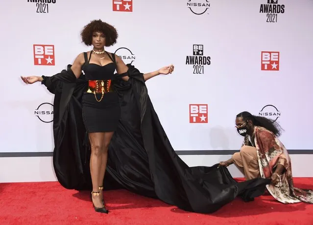 An assistant helps with Jennifer Hudson's outfit as she poses at the BET Awards on Sunday, June 27, 2021, at the Microsoft Theater in Los Angeles. (Photo by Jordan Strauss/Invision/AP Photo)