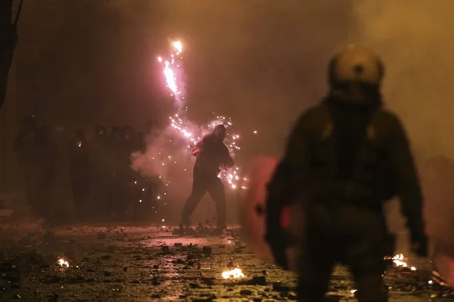 Protesters use fireworks against riot police during clashes in the Athens neighborhood of Exarchia, a haven for extreme leftists and anarchists, Thursday, December 6, 2018. New protest marches were underway in Greece Thursday evening on the 10th anniversary of the fatal police shooting of a teenager, hours after violent initial demonstrations where masked youths attacked police with firebombs and stones. (Photo by Yorgos Karahalis/AP Photo)