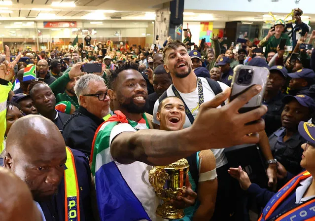 South Africa’s Siya Kolisi, Cheslin Kolbe and Eben Etzebeth take a selfie as they arrive with the Webb Ellis Cup after winning the Rugby World Cup in France in Johannesburg, South Africa on October 31, 2023. (Photo by Siphiwe Sibeko/Reuters)