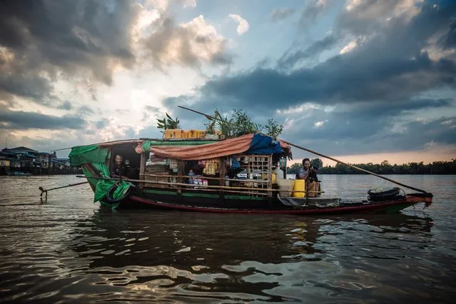 Tin and Naing win live on a small boat which they sail throughout the Delta region in Myanmar. The former gardeners once had a home on land but it was destroyed when a powerful cyclone ravaged the area in 2008. Since then, the couple have not been able to afford to rebuild their home, so they live on the boat from which they sell fish paste to make a living. (Photo by Muse Mohammed/IOM)