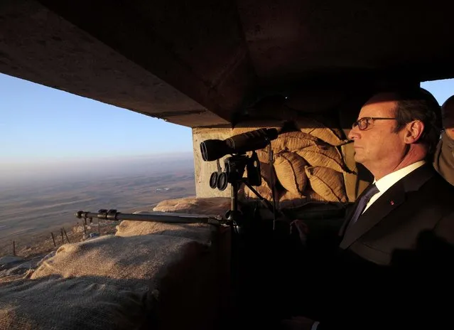 French President Francois Hollande looks out at Islamic State-held territory as he visits a military outpost on the outskirts of the  Islamic State-held city of Mosul, outside the Kurdish city of Erbil, Iraq, January 2, 2017. (Photo by Christophe Ena/Reuters)