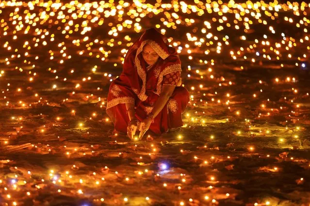 A woman during the “Deepotsav” celebration on the occasion of Diwali festival, in Jaipur, Rajasthan, India, Saturday night, November 11, 2023. (Photo by Vishal Bhatnagar/NurPhoto/Rex Features/Shutterstock)