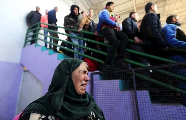 A Palestinian woman reacts as she waits to cross into Egypt through the Rafah border crossing between Egypt and the southern Gaza Strip February 13, 2016. Egypt opened the Rafah border crossing on Saturday for two days to allow Palestinians on humanitarian grounds to travel in and out of the Gaza Strip, officials said. (Photo by Ibraheem Abu Mustafa/Reuters)