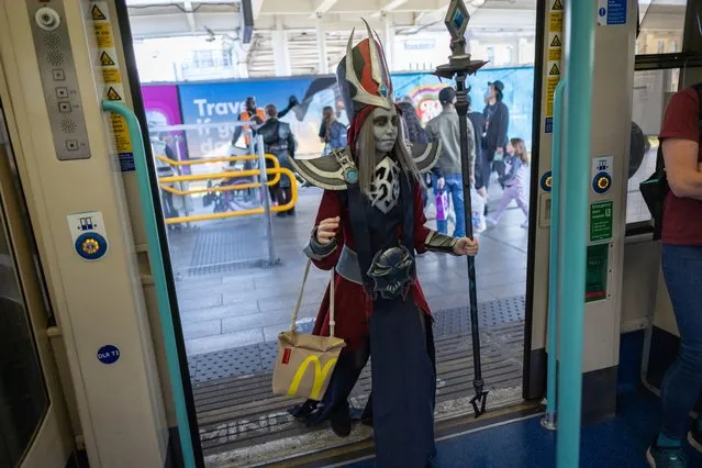 A cosplayer dressed as Karthus from League of Legends takes a DLR train after attending the MCM Comic Con at the ExCeL London exhibition and convention center in London, Britain, 27 May 2023. The MCM London Comic Con runs from 26 to 28 May 2023, with thousands of cosplayers, film, video games and anime fans attending the biannual event usually held on the last weekend of May and October. (Photo by Tolga Akmen/EPA/EFE)