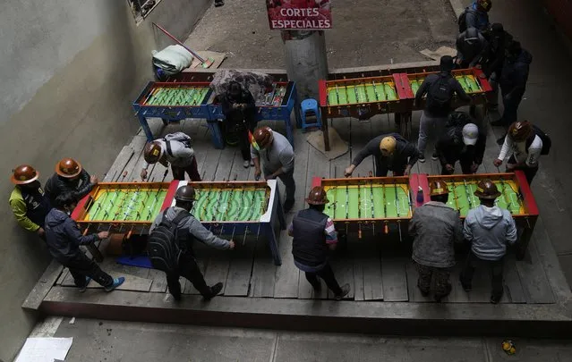 Striking independent miners play table football during a break in their protest against the government in La Paz, Bolivia, Thursday, August 26, 2021. The miners continued their protests for the second day to demand the resignation of the country´s mining minister, claiming that the government is not meeting their demands to implement measures to reactivate the sector, which has been severely affected during the pandemic. (Photo by Juan Karita/AP Photo)
