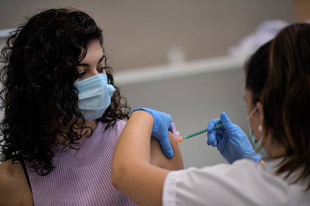A woman receives the Pfizer COVID-19 vaccine during the national COVID-19 vaccination campaign in Pamplona, northern Spain, Thursday, September 2, 2021. Spanish authorities say more than seventy percent of citizens have been vaccinated. (Photo by Alvaro Barrientos/AP Photo)