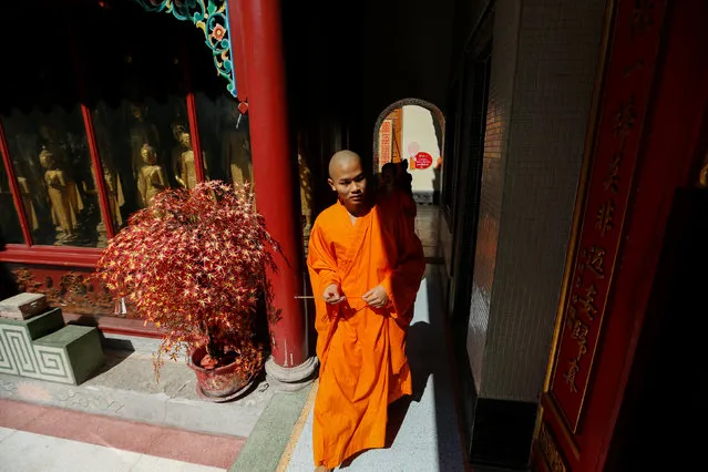 A Buddhist monk walks inside a temple during the Lunar New Year eve celebration in Bangkok, Thailand January 27, 2017. (Photo by Jorge Silva/Reuters)