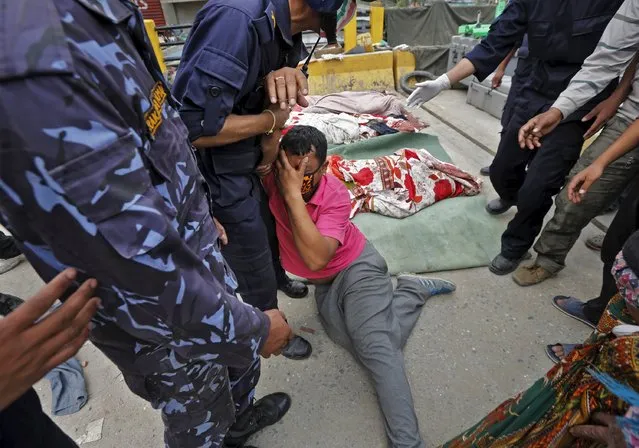 Ganesh Giri, 36, mourns next to his wife’s body after it was recovered by the rescue team from a collapsed building, after Saturday’s earthquake, in Kathmandu, Nepal April 29, 2015. (Photo by Adnan Abidi/Reuters)
