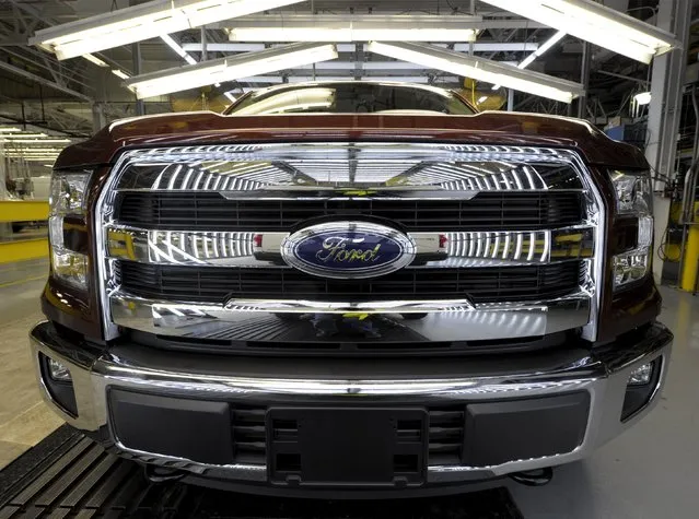 The front grill of a finished Ford F150 pickup reflects the inspection light on the final line of Ford's Kansas City Assembly Plant where new aluminum intensive Ford F-Series pickups are built in Claycomo, Missouri May 5, 2015. (Photo by Dave Kaup/Reuters)