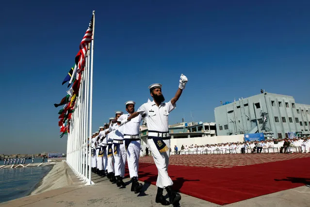 Pakistan Navy's servicemen march after hoisting the national flags of participating countries during the opening ceremony of Pakistan Navy’s Multinational Exercise AMAN-17, in Karachi, Pakistan February 10, 2017. (Photo by Akhtar Soomro/Reuters)