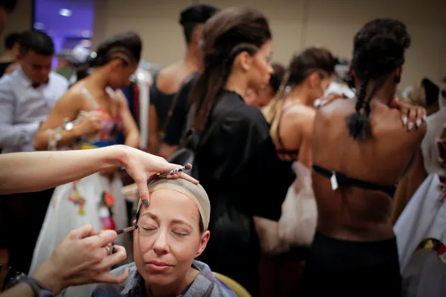 Tiffany Schwantes, one of a group of advanced-stage cancer patients to model as part of the SMGlobal Catwalk presentation for Say Yes to HOPE, is prepared backstage before modeling during New York Fashion Week in Manhattan, New York, U.S., February 11, 2017. (Photo by Andrew Kelly/Reuters)