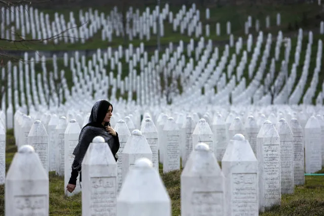 In this photo taken on Sunday, March 20, 2016, a Bosnian woman walks among gravestones at Memorial Centre Potocari near Srebrenica, Bosnia and Herzegovina. Former Bosnian Serb leader Radovan Karadzic will hear his verdict on Thursday, March 24, 2016 and prosecutors of the U.N. war crimes tribunal have called for life in prison for 11 counts of war crimes, including genocide he is accused of having masterminded during Bosnia's 1992-95 war. (Photo by Amel Emric/AP Photo)