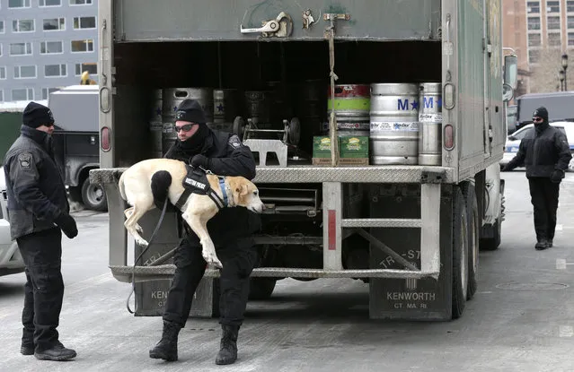 Boston Police Special Operations officers use a bomb-sniffing dog while searching a vehicle on a street near the federal courthouse, in Boston, Tuesday, March 3, 2015. A panel of 12 jurors and six alternates was seated Tuesday after two months of jury selection for the federal death penalty trial of Boston Marathon bombing suspect Dzhokhar Tsarnaev. (Photo by Steven Senne/AP Photo)