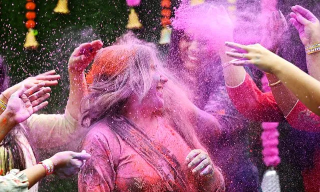 Women smeared with ‘Gulal' as they celebrate Holi, the Hindu spring festival of colours, in Chennai on March 25, 2024. (Photo by R.Satish Babu/AFP Photo)