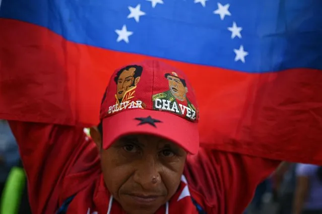 A supporter of Venezuelan President Nicolas Maduro takes part in a rally to commemorate 20 years of the anti-imperialist declaration of the late former President Hugo Chavez in Caracas on February 29, 2024. (Photo by Federico Parra/AFP Photo)