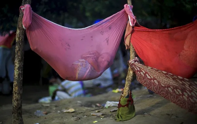 A girl lies in a hammock at a slum area in New Delhi, in this April 12, 2015 file photo. (Photo by Adnan Abidi/Reuters)