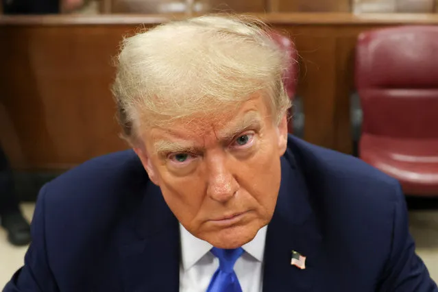 Former U.S. president and Republican presidential candidate Donald Trump awaits the start of proceedings for allegedly covering up hush money payments linked to extramarital affairs at Manhattan criminal court in New York, on April 22, 2024. (Photo by Yuki Iwamura/Pool via Reuters(