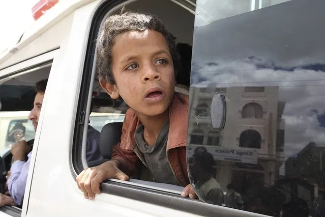 A boy looks out of the window of a Yemen Red Crescent vehicle as he leaves an underground water tunnel with other displaced people, after they were forced to flee their home due to ongoing air-strikes carried out by the Saudi-led coalition in Sanaa May 2, 2015. (Photo by Mohamed al-Sayaghi/Reuters)