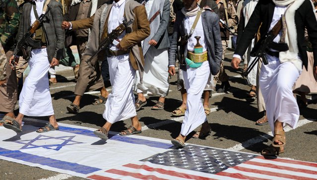 New Houthi recruits march on Israeli and U.S. flags as they parade in solidarity with the Palestinians in the Gaza Strip, in Sanaa, Yemen on March 7, 2024. (Photo by Khaled Abdullah/Reuters)