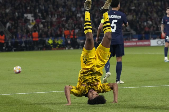 Dortmund's Karim Adeyemi flips after a challenge with PSG's Marquinhos during the Champions League semifinal second leg soccer match between Paris Saint-Germain and Borussia Dortmund at the Parc des Princes stadium in Paris, France, Tuesday, May 7, 2024. (Photo by Frank Augstein/AP Photo)