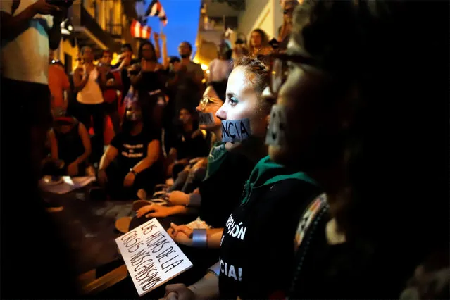 People protest against the Governor of Puerto Rico, Ricardo Rosello, in front of the Government headquarters, known as La Fortaleza, in San Juan, Puerto Rico, 18 July 2019. Thousands of people have participated in the daily protests in the Puerto Rican capital to demand the resignation of Rosello, immersed in a political scandal for the dissemination of the content of a private chat. (Photo by Thais Llorca/EPA/EFE)