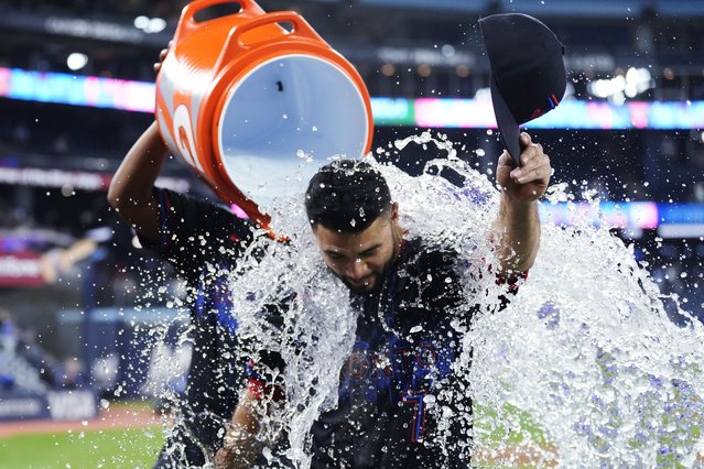 Toronto Blue Jays' Isiah Kiner-Falefa (7) is doused after the team's win over the Baltimore Orioles in a baseball game Wednesday, June 5, 2024, in Toronto. (Photo by Frank Gunn/The Canadian Press via AP Photo)