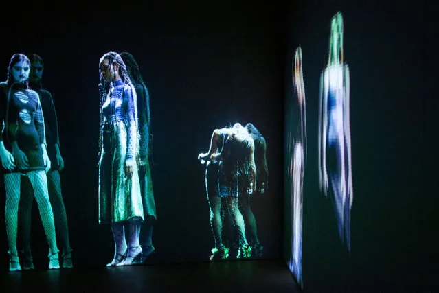 Holograms display creations by designer Maisie Wilen during New York Fashion Week: The Shows, in New York City on February 12, 2022. The show features 28 seven-foot-tall augmented reality hologram models. (Photo by Kena Betancur/AFP Photo)
