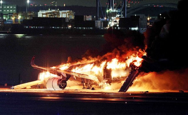 This photo provided by Jiji Press shows a Japan Airlines plane on fire on a runway of Tokyo's Haneda Airport on January 2, 2024. A Japan Airlines plane was in flames on the runway of Tokyo's Haneda Airport on January 2 after apparently colliding with a coast guard aircraft, television reports said. (Photo by JIJI Press/AFP Photo)