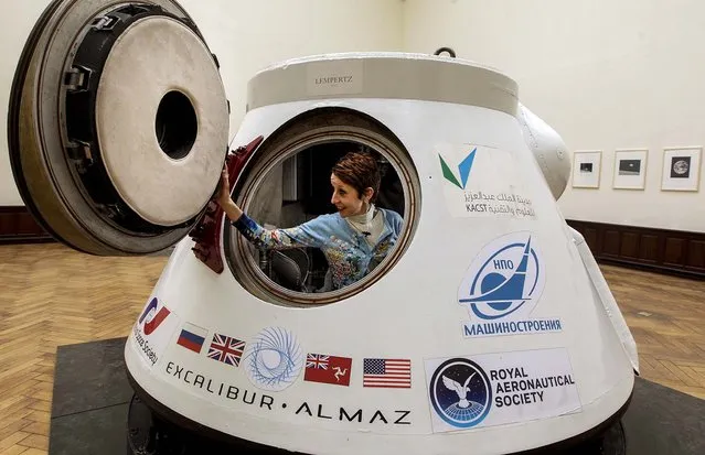 Lempertz auction house representative Christine de Schaetzen sits in the Soviet space capsule “Vozvrashchayemyi Apparat” in Brussels, on March 29, 2014. The estimated value of the space capsule that went twice into space in 1977 and 1978, is between $968,450 and $1.9 million. it will be auctioned on May 7. (Photo by Yves Logghe/Associated Press)