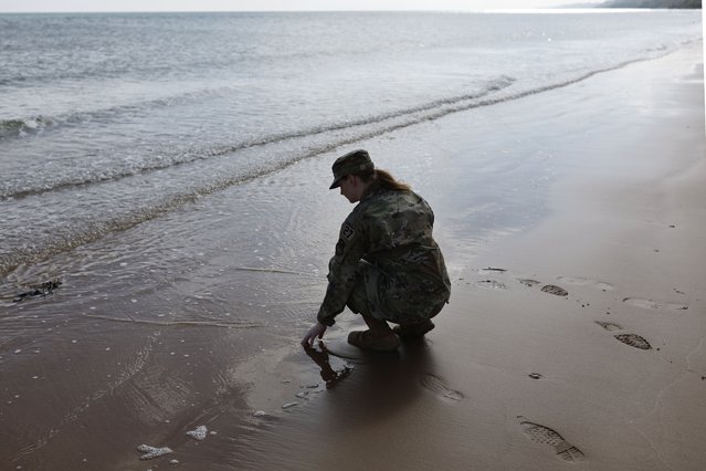 An American soldier touches the sand on Omaha Beach, Tuesday, June 4, 2024 in Normandy. World War II veterans from across the United States as well as Britain and Canada are in Normandy this week to mark 80 years since the D-Day landings that helped lead to Hitler's defeat. (Photo by Jeremias Gonzalez/AP Photo)